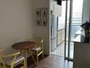 Small dining area with table and two chairs adjacent to modern kitchen