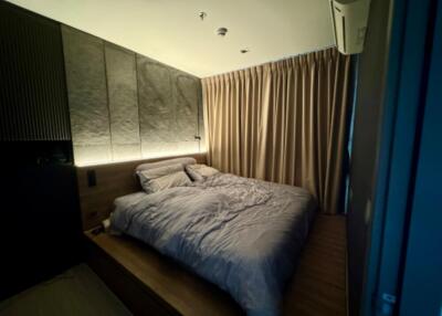 Modern bedroom with mood lighting and drapes