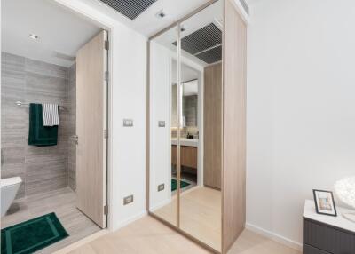 Modern bathroom and closet area with mirrors