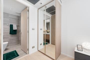 Modern bathroom and closet area with mirrors