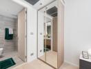 Modern bathroom and closet area with mirrors