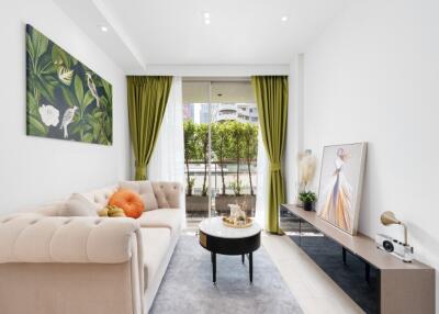 Modern living room with green curtains and artwork