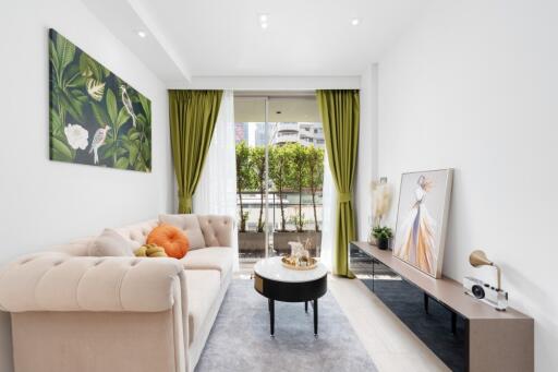 Modern living room with green curtains and artwork