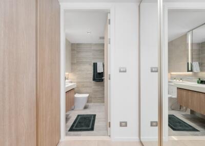 Modern bathroom with wooden cabinets and towel racks