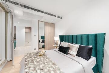 Modern bedroom with green headboard and decorative pillows