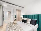 Modern bedroom with green headboard and decorative pillows