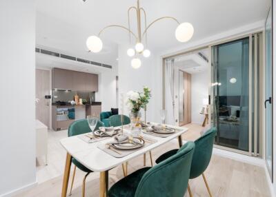 Modern dining area with elegant decor, adjacent kitchen and view into living room