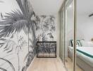 Stylish bedroom with tropical-themed wallpaper and glass sliding door