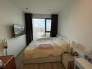 Spacious bedroom with a large window and city view