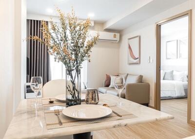 Modern dining area with a glimpse of the living room