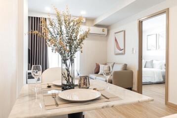 Modern dining area with a glimpse of the living room