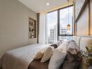 Modern bedroom with a large window and cozy bedding