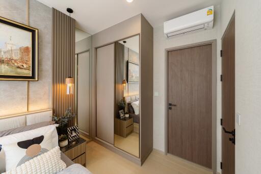 A well-decorated bedroom with modern furnishings, a mirrored wardrobe, and air conditioning.