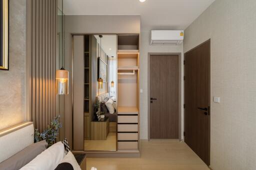 Modern bedroom with a mirror wardrobe and wooden door