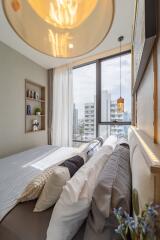 Cozy and modern bedroom with a large window offering city views.