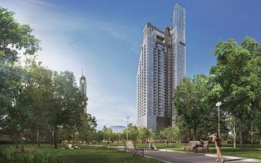 Exterior view of a high-rise residential building surrounded by a park with green trees and walking paths