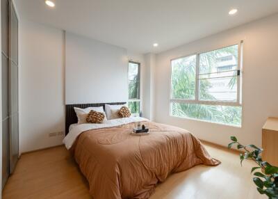 Bright modern bedroom with a comfortable bed and large windows