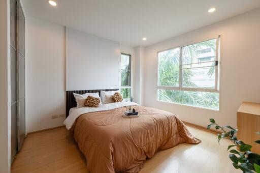 Bright modern bedroom with a comfortable bed and large windows