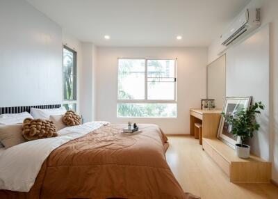 Modern bedroom with large window and natural light