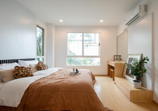 Modern bedroom with large window and natural light