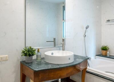 Modern bathroom with sink, mirror, and bathtub