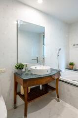 Modern bathroom with sink, mirror, and bathtub