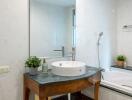 Modern bathroom with sink, mirror, and bathtub