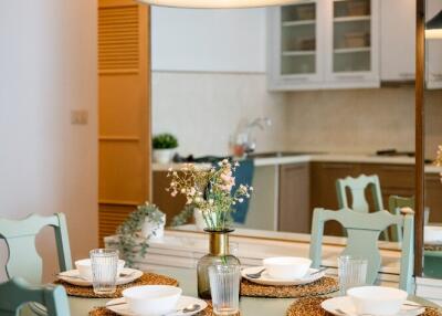 Dining area with table setting next to the kitchen