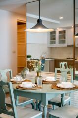 Dining area with table setting next to the kitchen