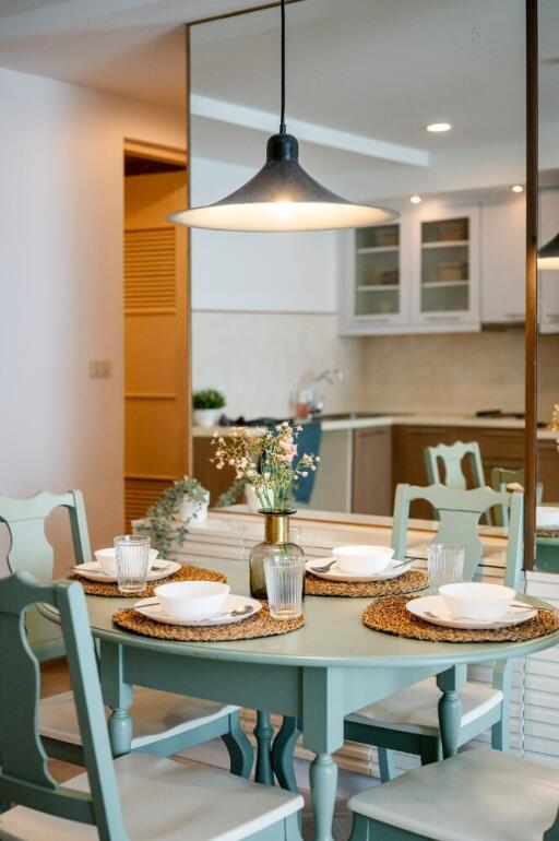 Dining area with table setting next to the kitchen