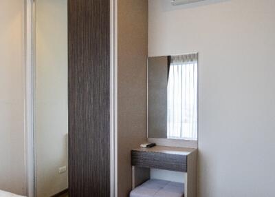 Modern bedroom with air conditioner and dressing table