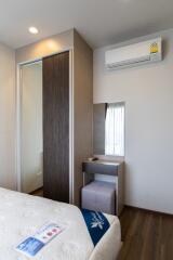 Modern bedroom with air conditioner and dressing table