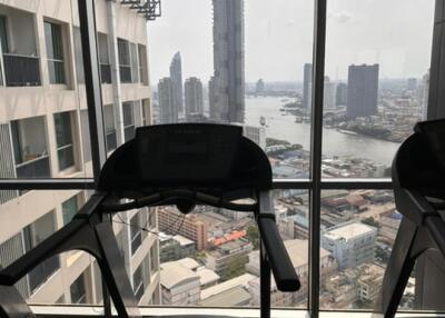 View from gym with exercise equipment and cityscape