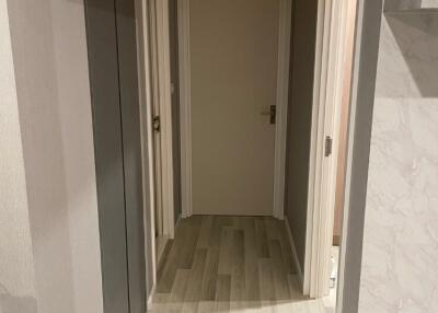 Modern hallway with wooden flooring and beige walls