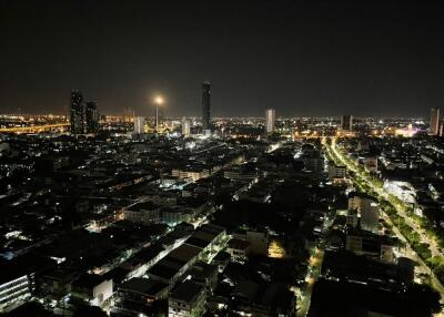 Night view of city skyline with tall buildings and illuminated streets