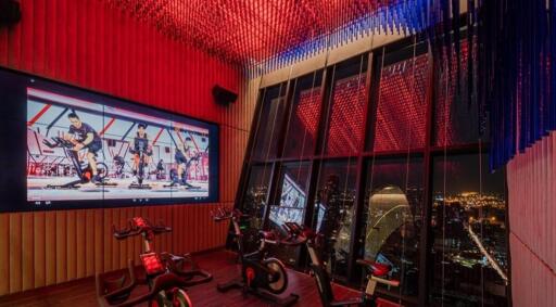 Indoor cycling studio with panoramic city view