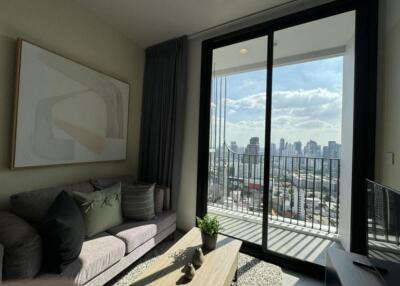 Modern living room with a large window offering a city view