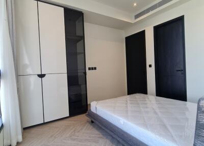 Modern-style bedroom with double-door wardrobe and minimalist decor