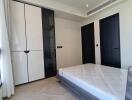 Modern-style bedroom with double-door wardrobe and minimalist decor