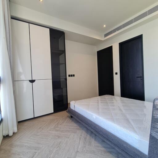 Modern-style bedroom with double-door wardrobe and minimalist decor