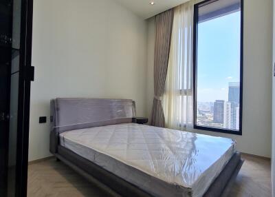 Modern bedroom with large window and city view