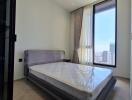 Modern bedroom with large window and city view