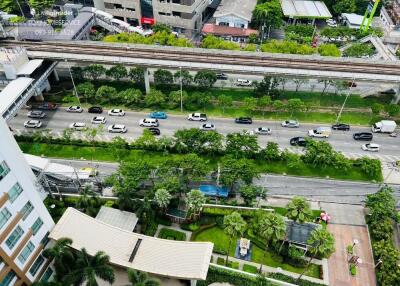 Aerial view of a building with surrounding roads and greenery