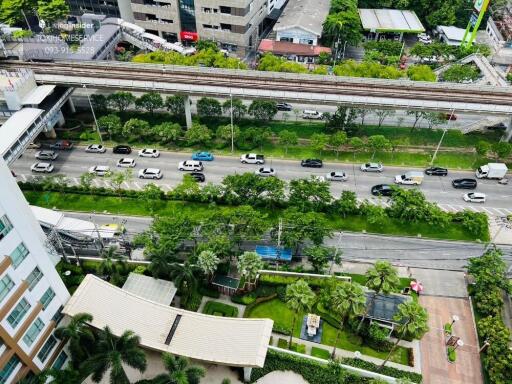 Aerial view of a building with surrounding roads and greenery