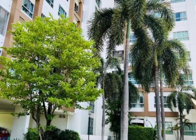 Exterior view of a multi-story residential building with landscaped garden