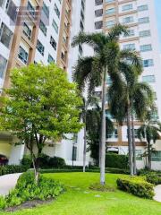 Exterior view of a multi-story residential building with landscaped garden