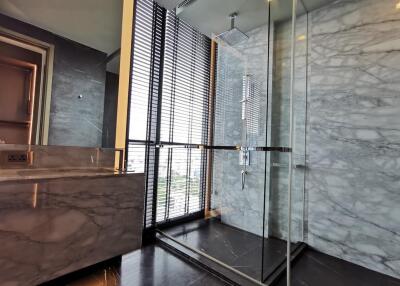 Modern bathroom with marble decor and walk-in shower