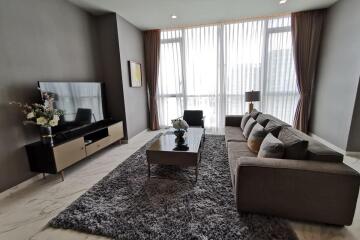 Modern living room with a large TV and comfortable seating