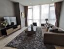 Modern living room with a large TV and comfortable seating