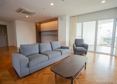 Spacious and well-lit living room with modern furniture